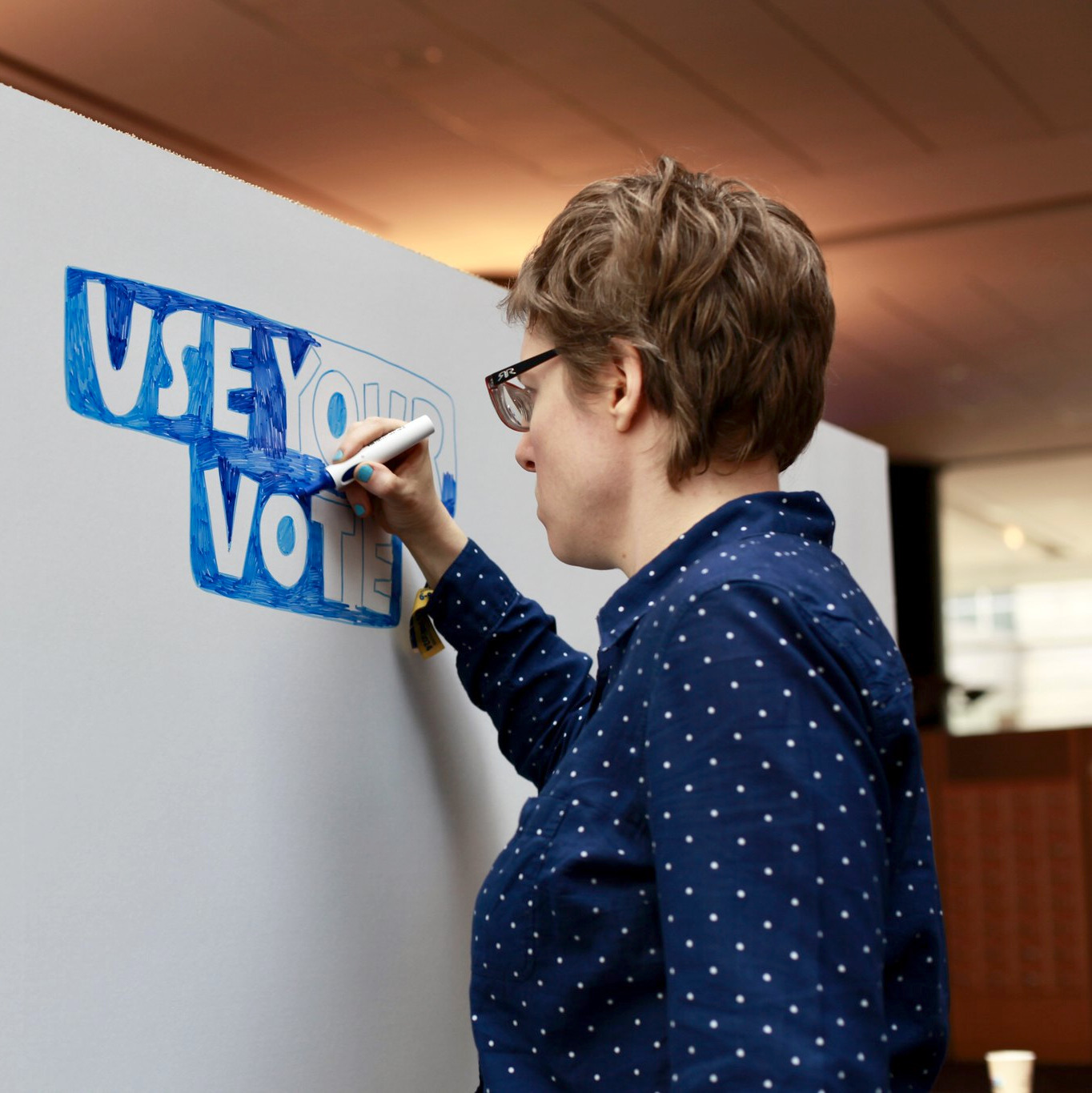 Image of a person writing on a board.